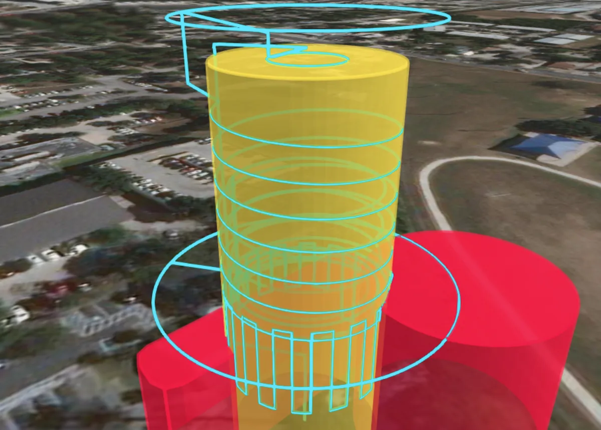 Vista previa 3D de una misión de escaneo de torre: una trayectoria de vuelo azul en espiral rodea un cilindro amarillo que representa la torre, y unos volúmenes rojos de exclusión marcan el recinto en la base